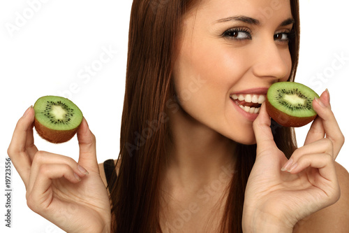 The girl eats a kiwi