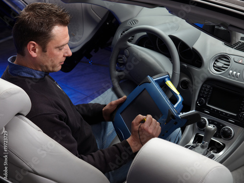 Master mechanic working with his diagnostic computer