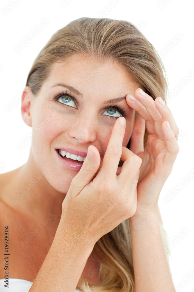 Attractive blond woman putting a contact lens Attractive blond woman putting a contact lens