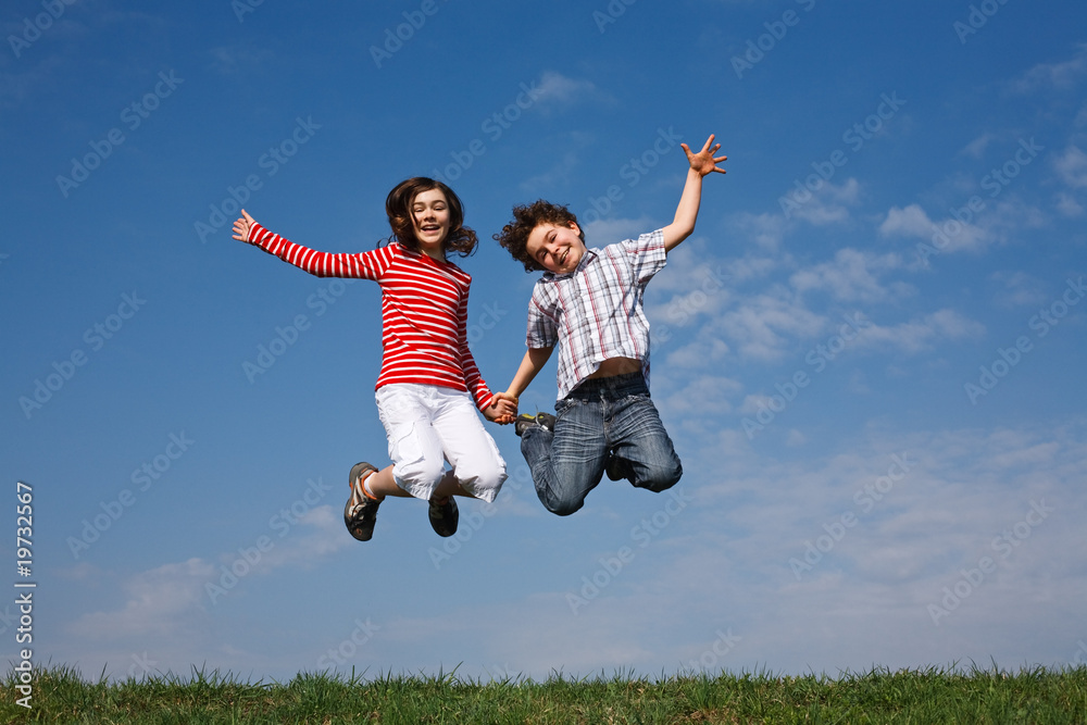 Kids jumping, running against blue sky Kids jumping, running against blue sky