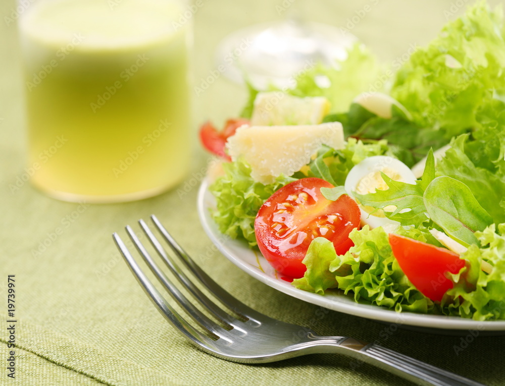 Fresh salad with tomato and quail eggs
