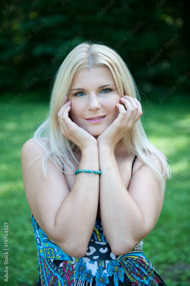 Fototapeta premium Pretty spring woman with pure healthy skin in the garden