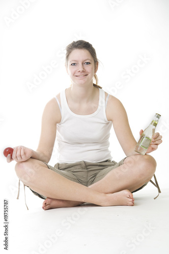 Woman meditating with fruit and beer photo