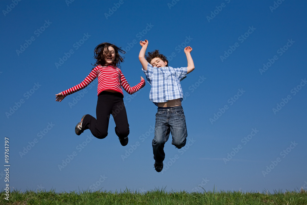 Kids jumping, running against blue sky Kids jumping, running against blue sky