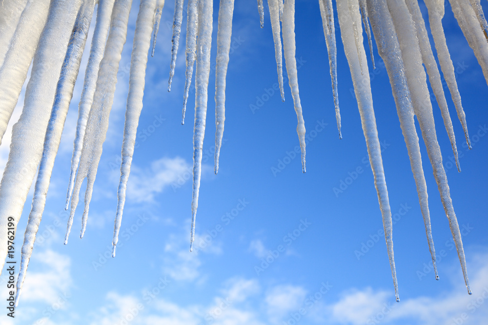 Icicles hanging against a blue sky Icicles hanging against a blue sky