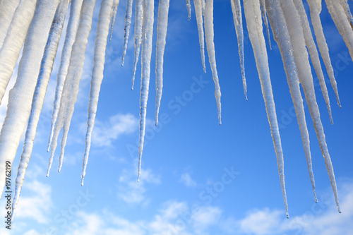 Icicles hanging against a blue sky