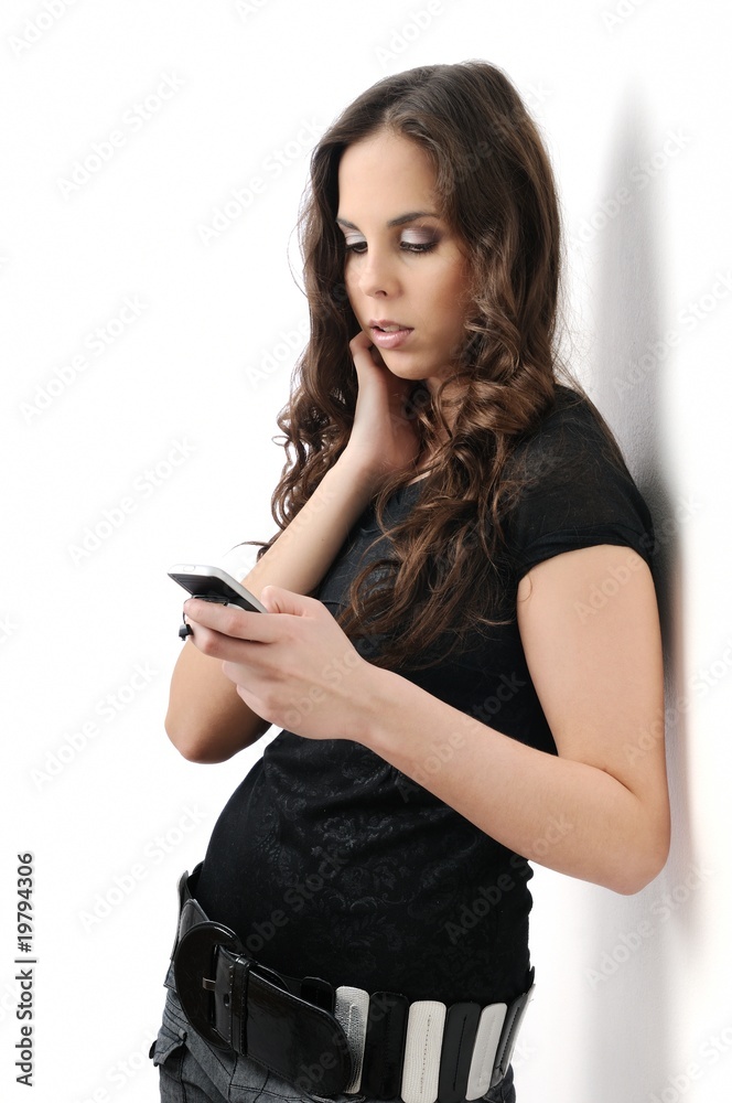 Fototapeta premium Teenager with mobile phone on white