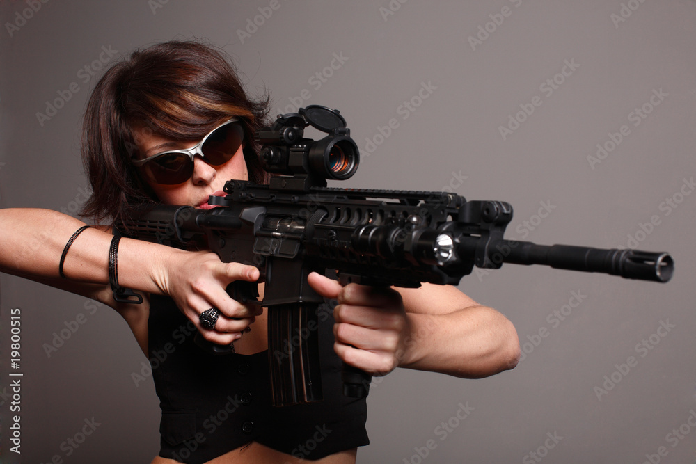 young fashionable woman with an M4 assault rifle young fashionable woman with an M4 assault rifle