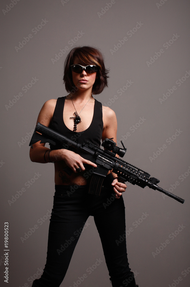 young fashionable woman with an M4 assault rifle young fashionable woman with an M4 assault rifle