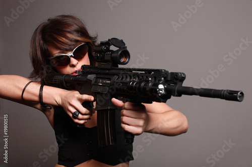 young fashionable woman with an M4 assault rifle © Peter Kim