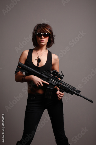 young fashionable woman with an M4 assault rifle