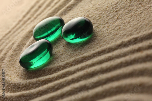 Photography green stones on a sand