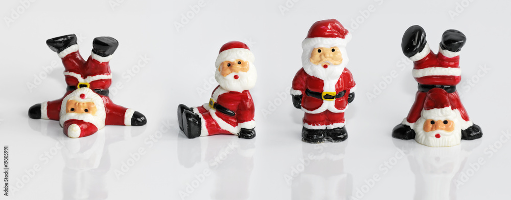 Four funny Santa Clause figurine isolated on white Four funny Santa Clause figurine isolated on white