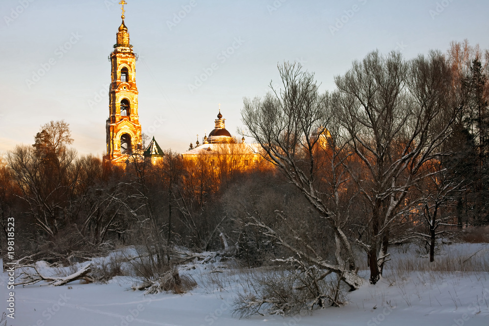 Fototapeta winter landscape with church in sun rays