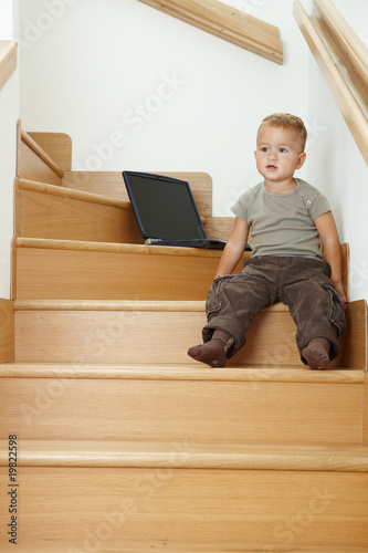 Little bay sitting on stairs