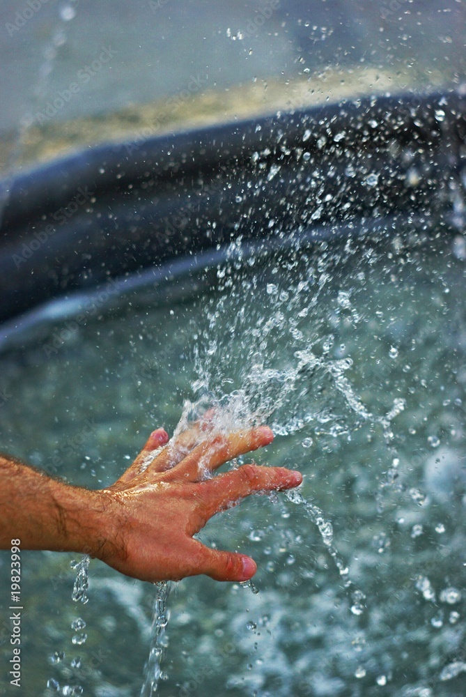 Hand in water stream