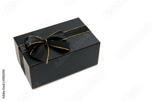Black giftbox with a black and gold knot white isolated