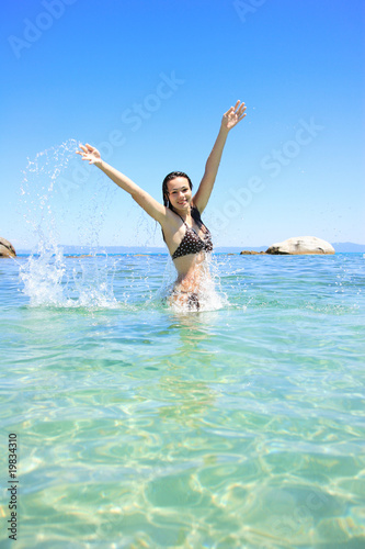 Happy young woman in sea