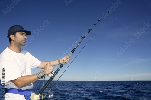 Angler fisherman trolling rod and reel fishing