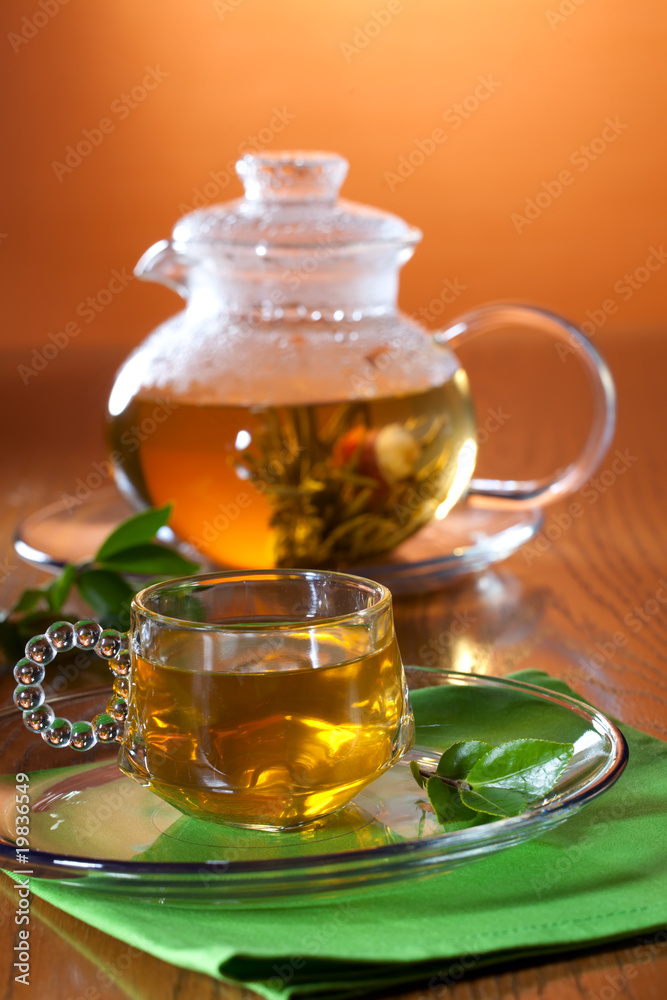 Glass of greean tea and teapot Glass of greean tea and teapot