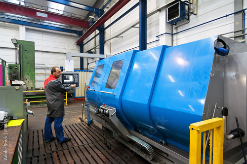 Older workers in the metal industry with CNC milling machine. photo