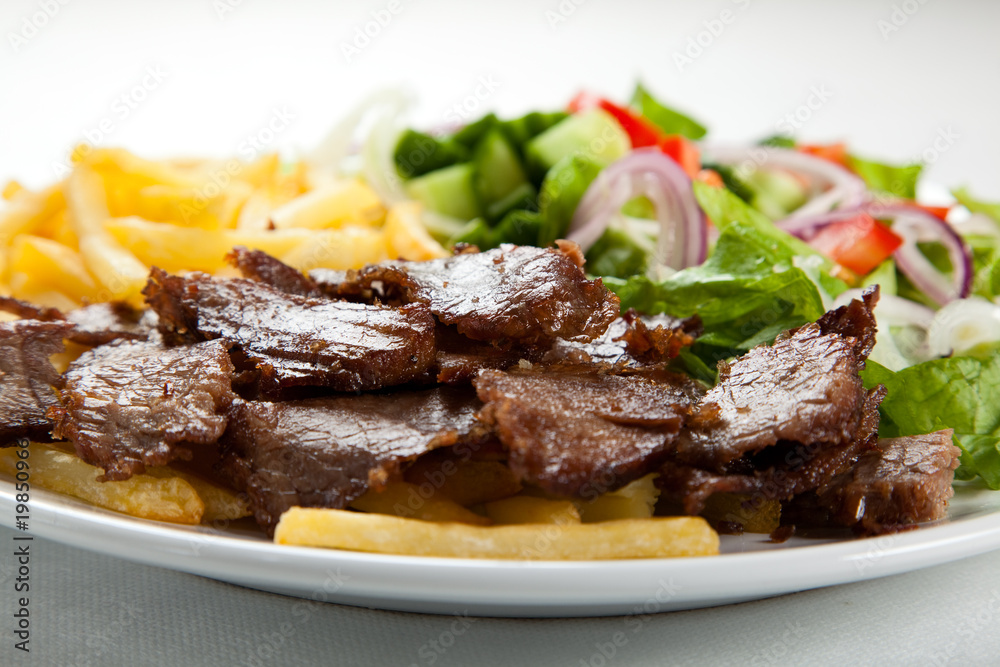 Grilled meat with fried potatoes and vegetables