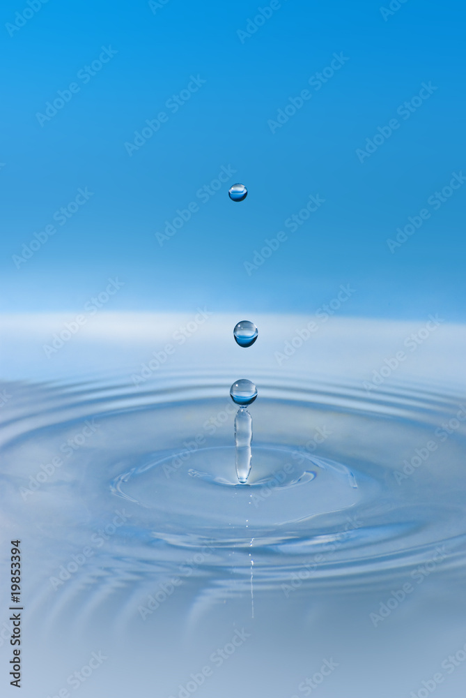 Clean blue drop of water splashing in clear water. Abstract blue Clean blue drop of water splashing in clear water. Abstract blue