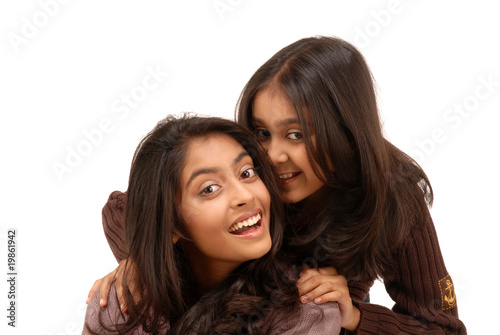 portrait of two indian girls over white background