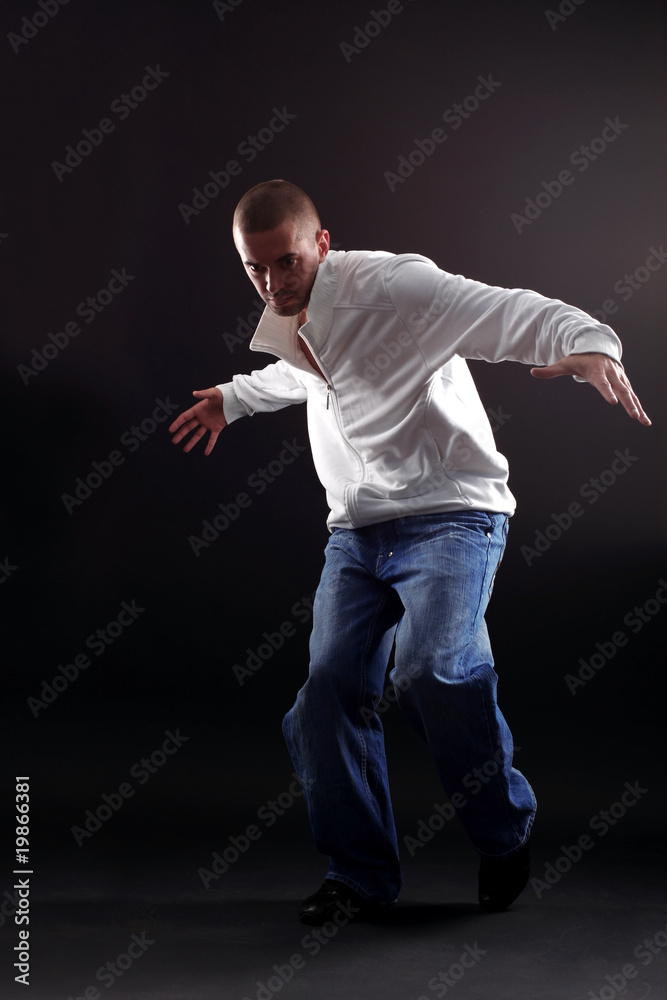 cool modern dancer in action against black background