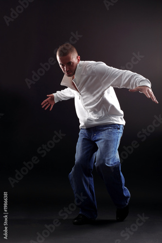 cool modern dancer in action against black background