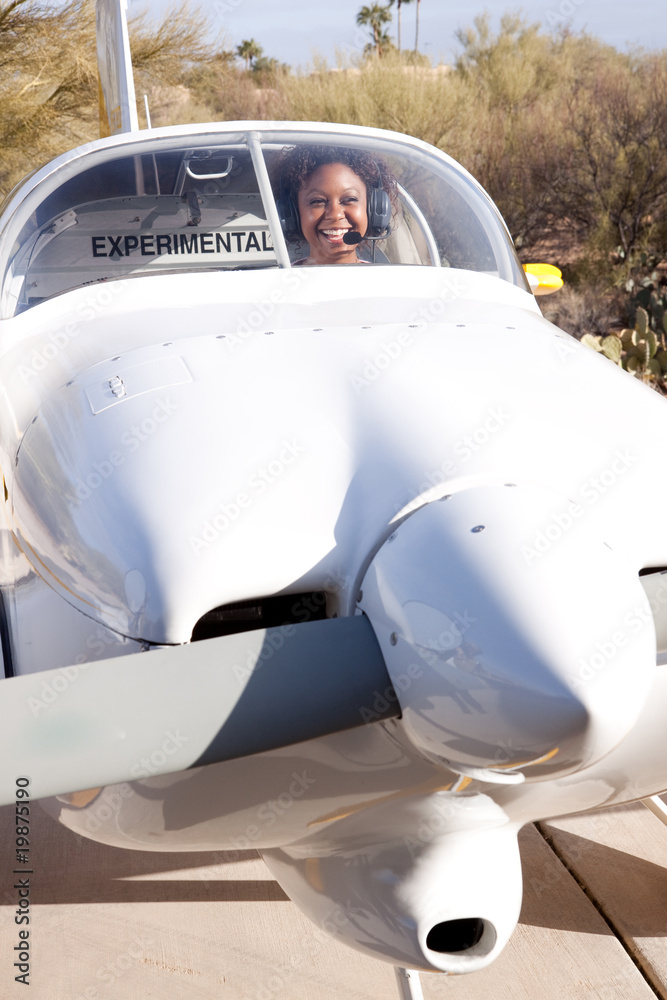Fototapeta premium African American woman flying a private plane