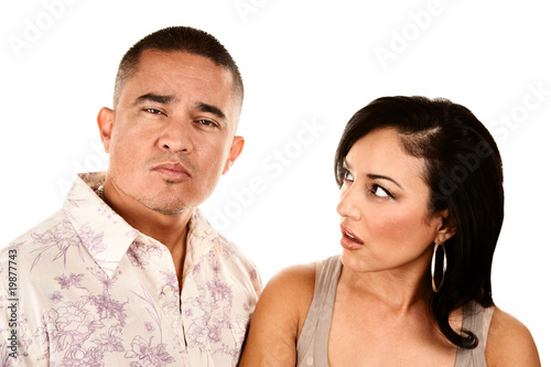 Hispanic wife looks suspiciously at her husband © Scott Griessel