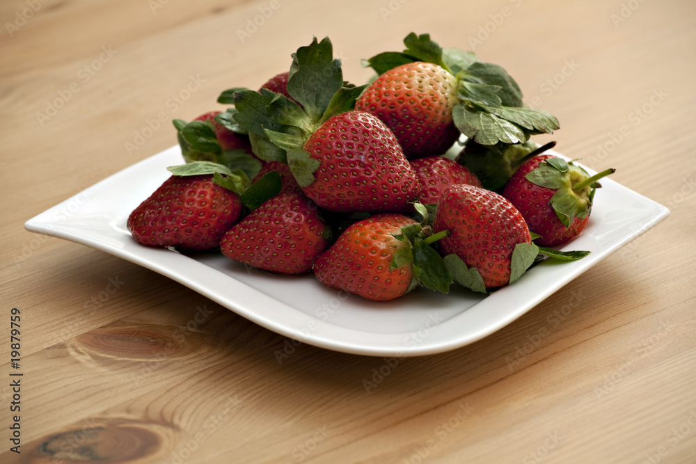 strawberries on white dish