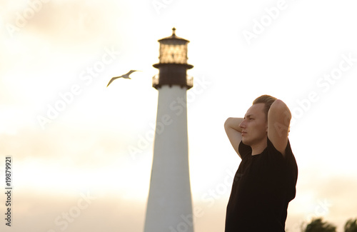 man and lighthouse photo