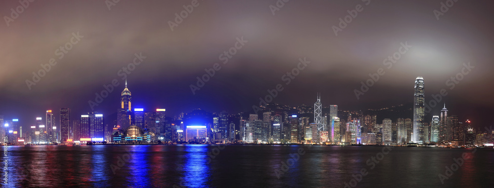 Panorama of the skyline of Hong Kong at night, with mist