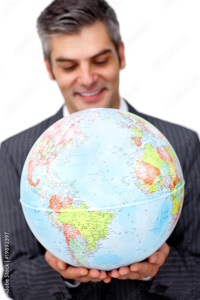 Mature businessman smiling at global business expansion Mature businessman smiling at global business expansion