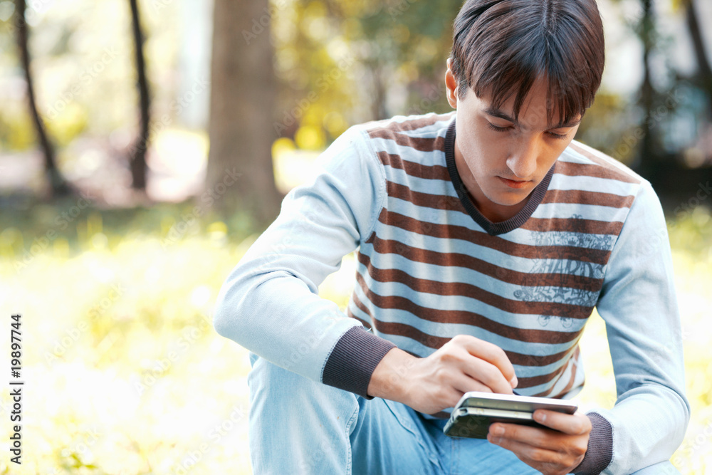 Young man with his pocket computer Young man with his pocket computer