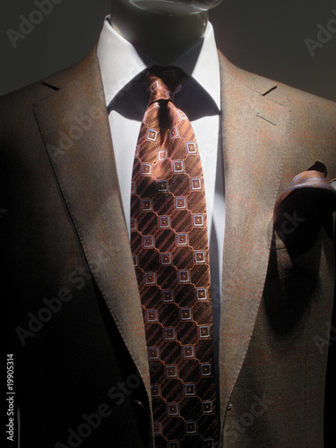 Brown jacket and tie.
