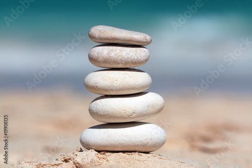 Stack of white stones composed as tower on the beach