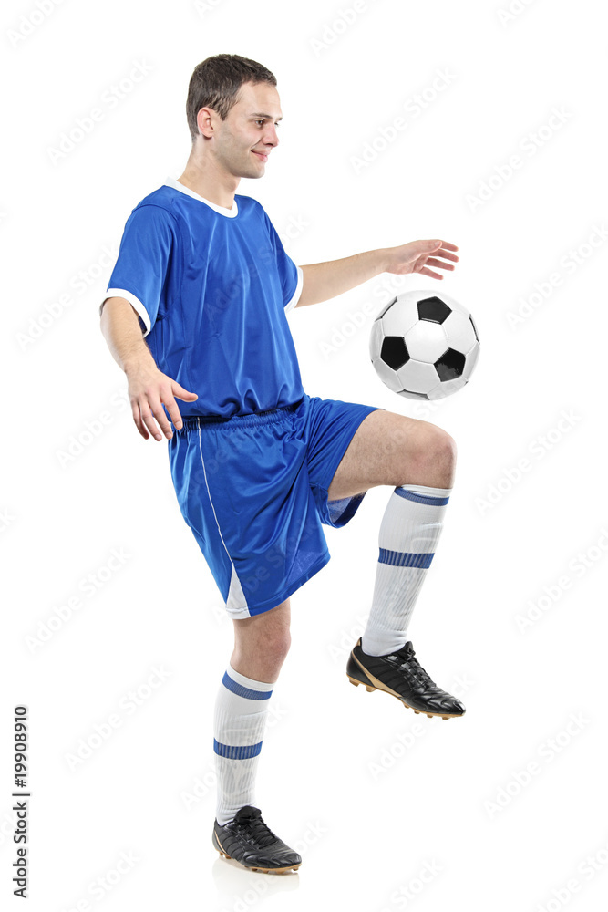 Soccer player with a ball isolated against white
