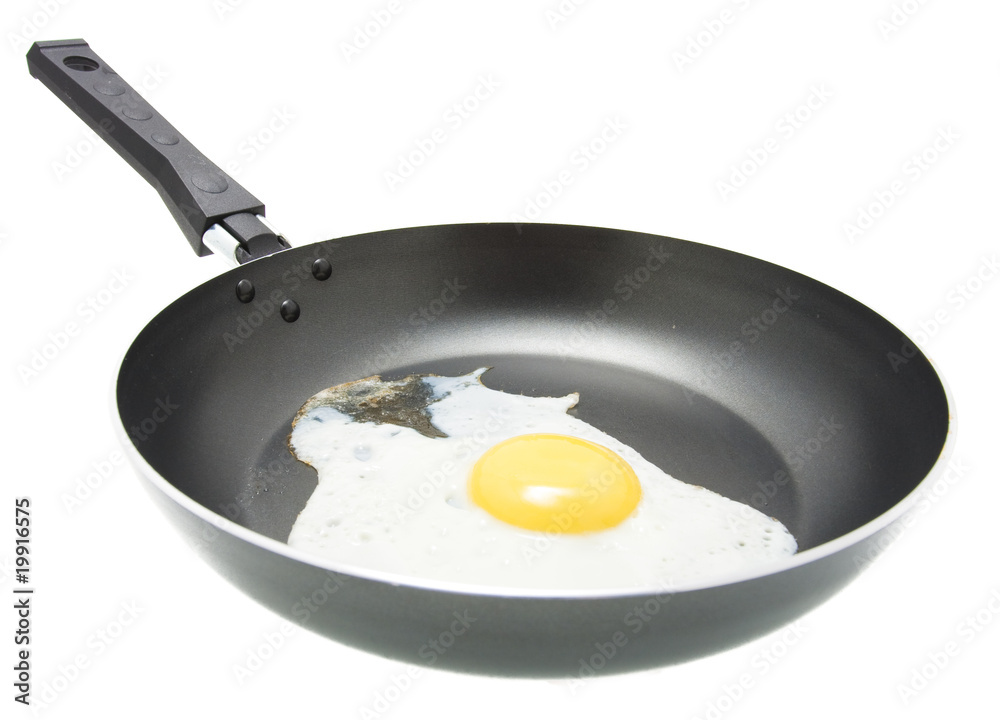 A fried egg in a frying pan isolated A fried egg in a frying pan isolated