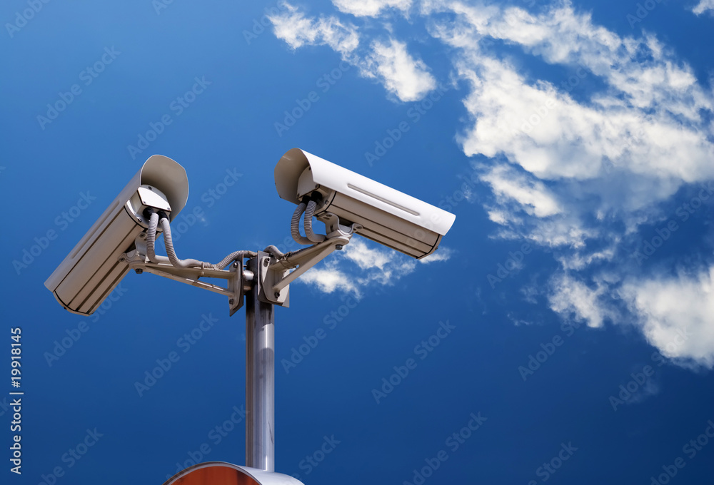 security camera under blue sky security camera under blue sky
