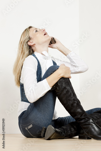 sitting woman with mobile phone