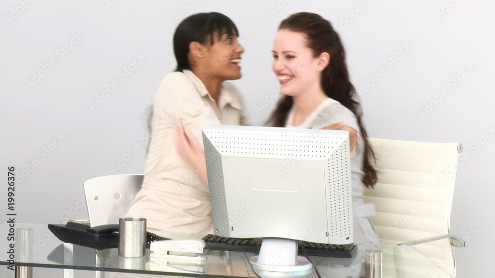 Businesswomen having fun at their desk Businesswomen having fun at their desk