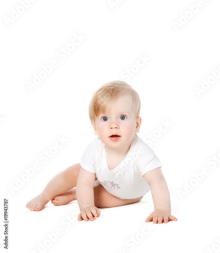 cute baby girl sitting and watching in amazement at the camera
