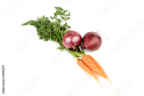 Bunch on raw crunchy carrots on a reflective white background