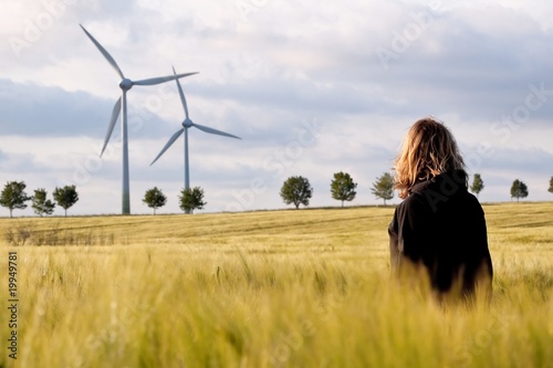 Woman in the barley with windmills photo