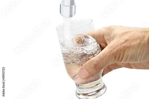 glass of water under the tap photo