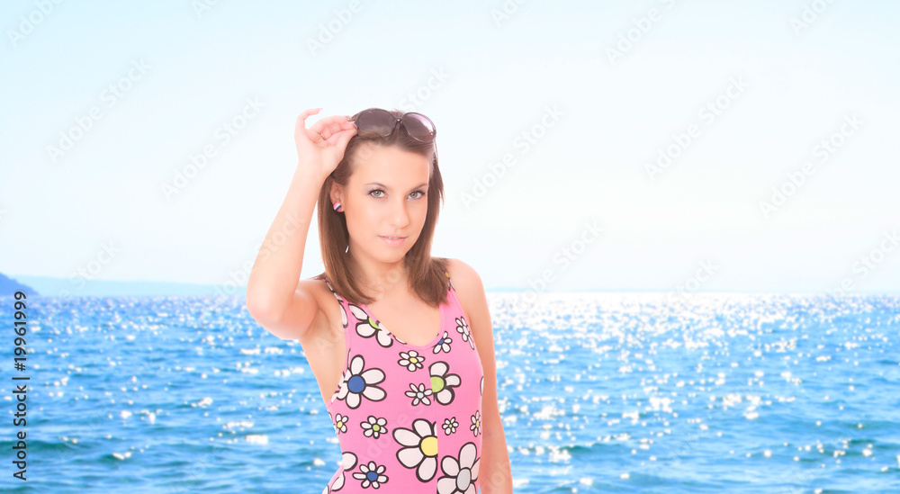 Beautiful young woman relaxing by the beach