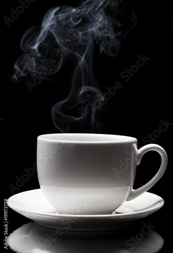white cup with steam coming out of it.